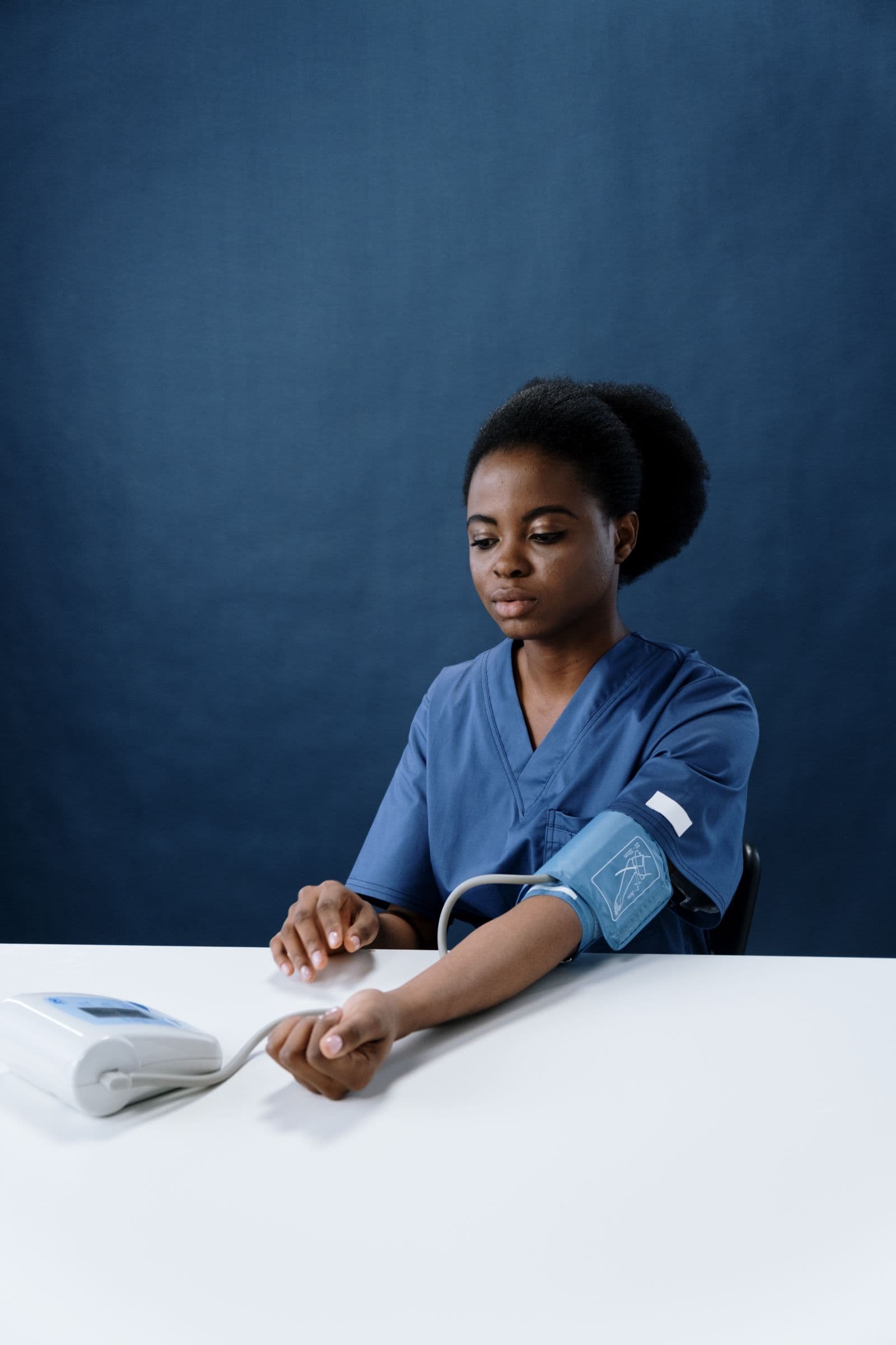 A Caribbean nurse taking a patient's blood pressure